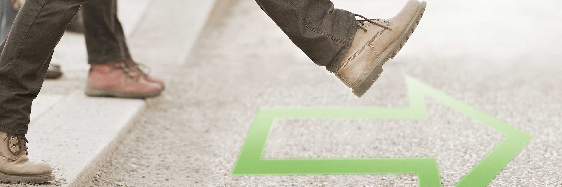 man walking forward over arrow