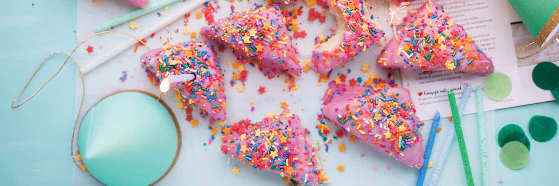 triangle cookies with sprinkles and pink icing