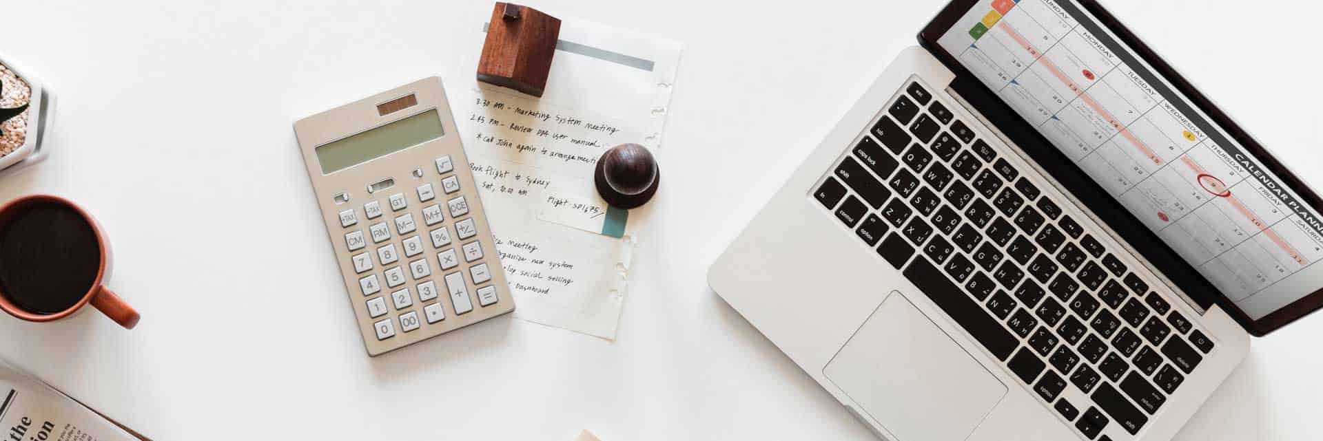 calculator and laptop on desk