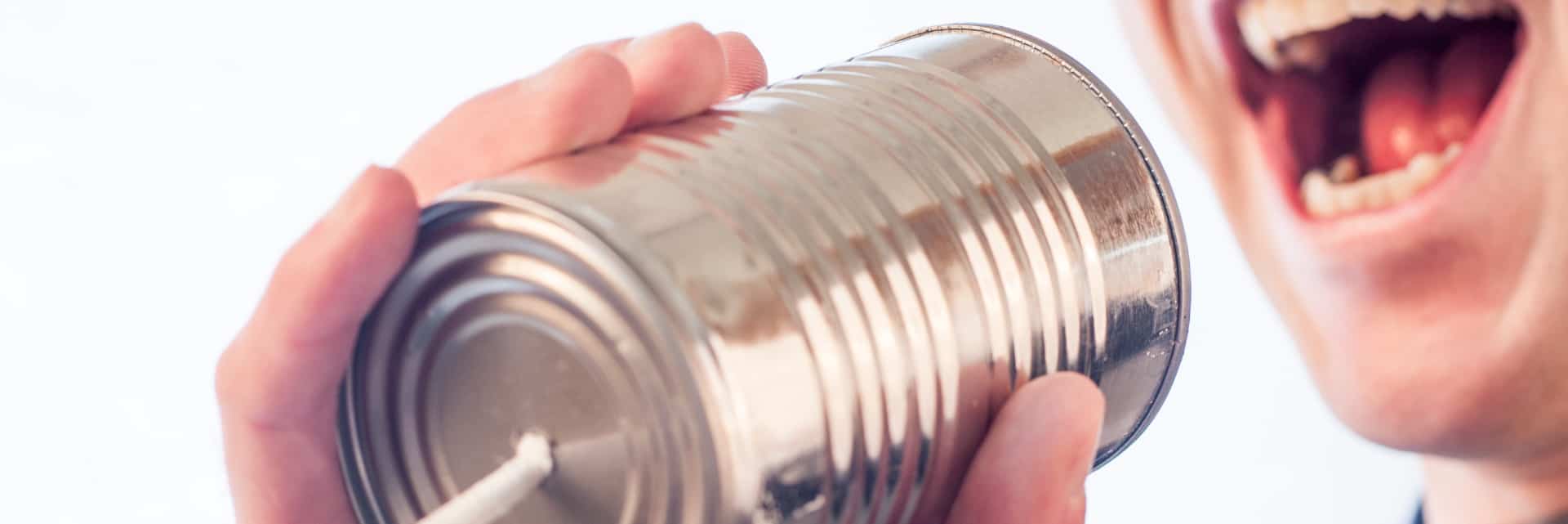 person talking into empty food can
