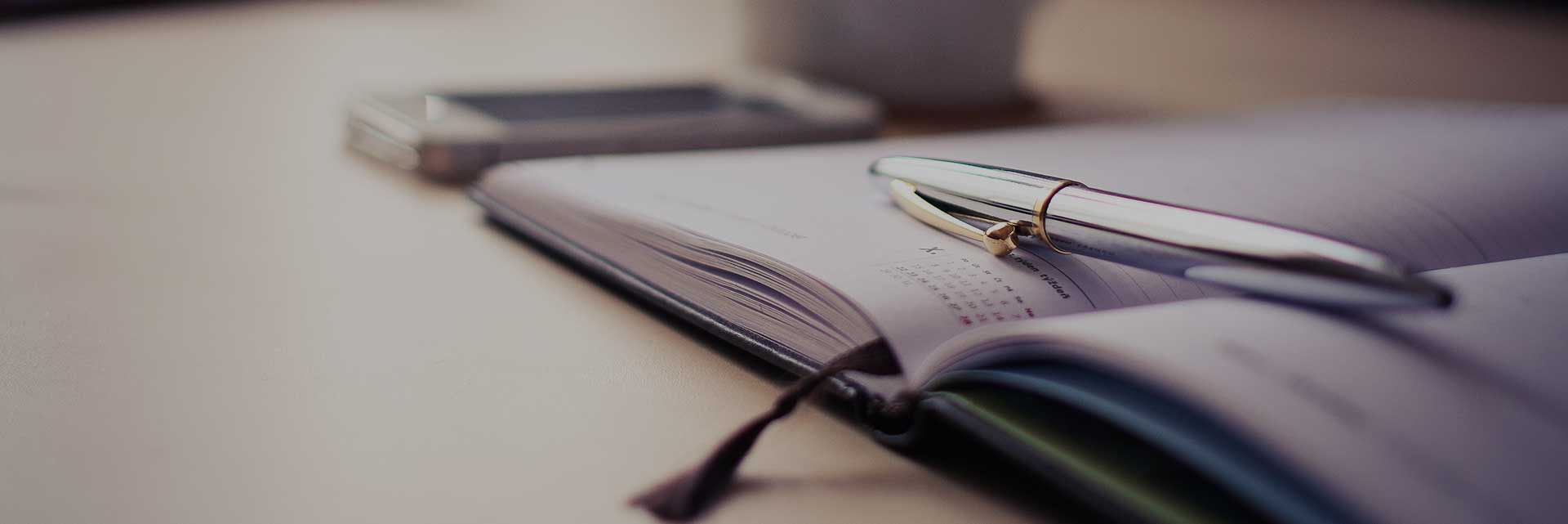 pen on open calendar book