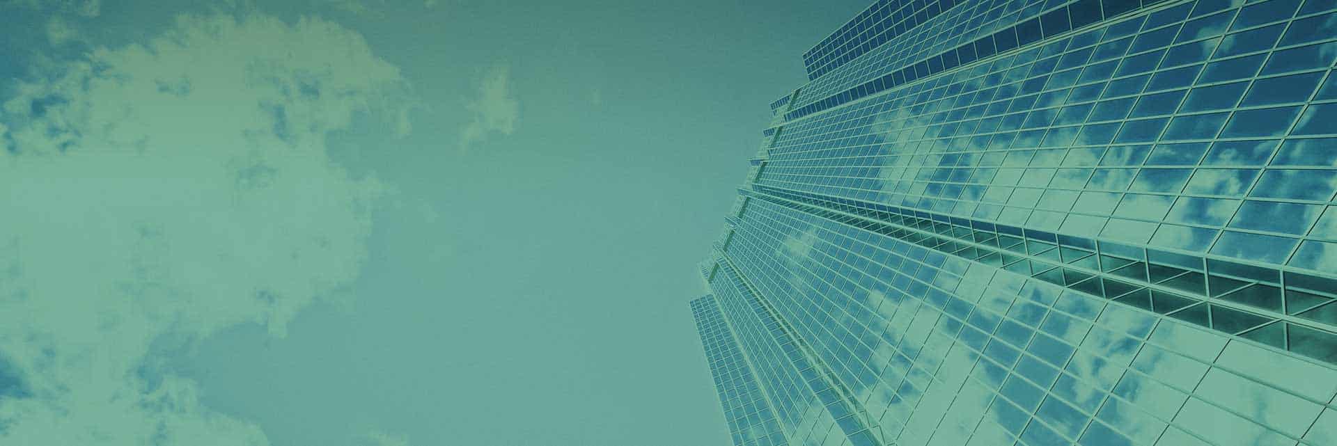 green skyscaper and sky