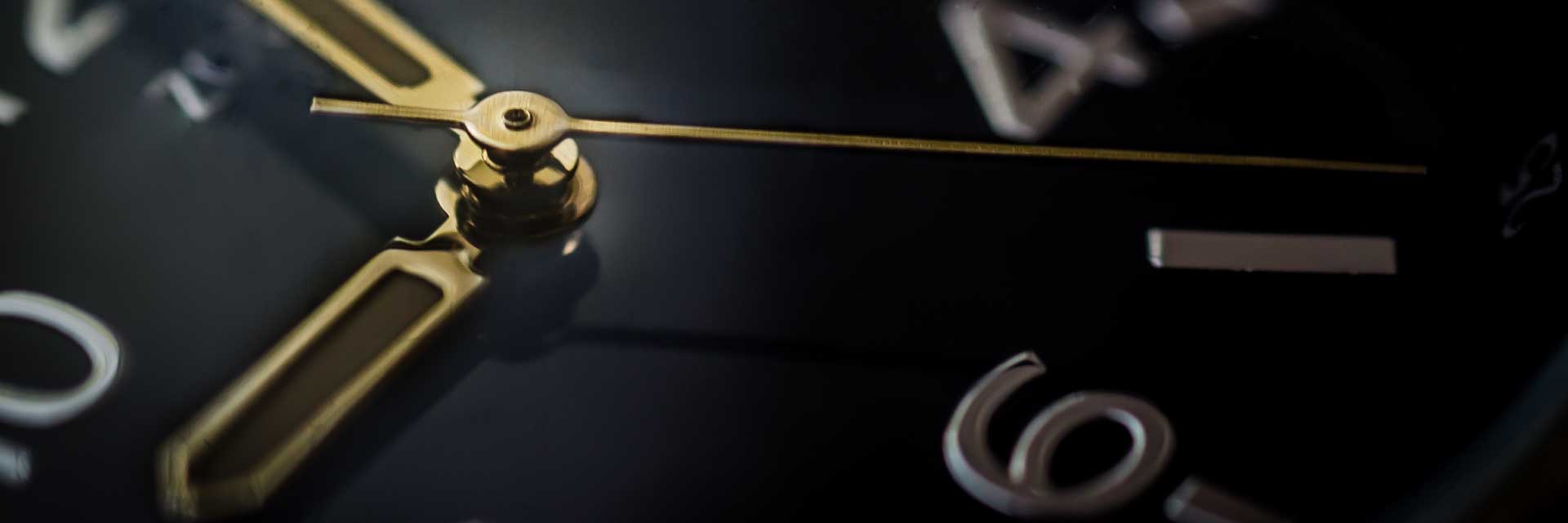 close up of clock hands and number 6