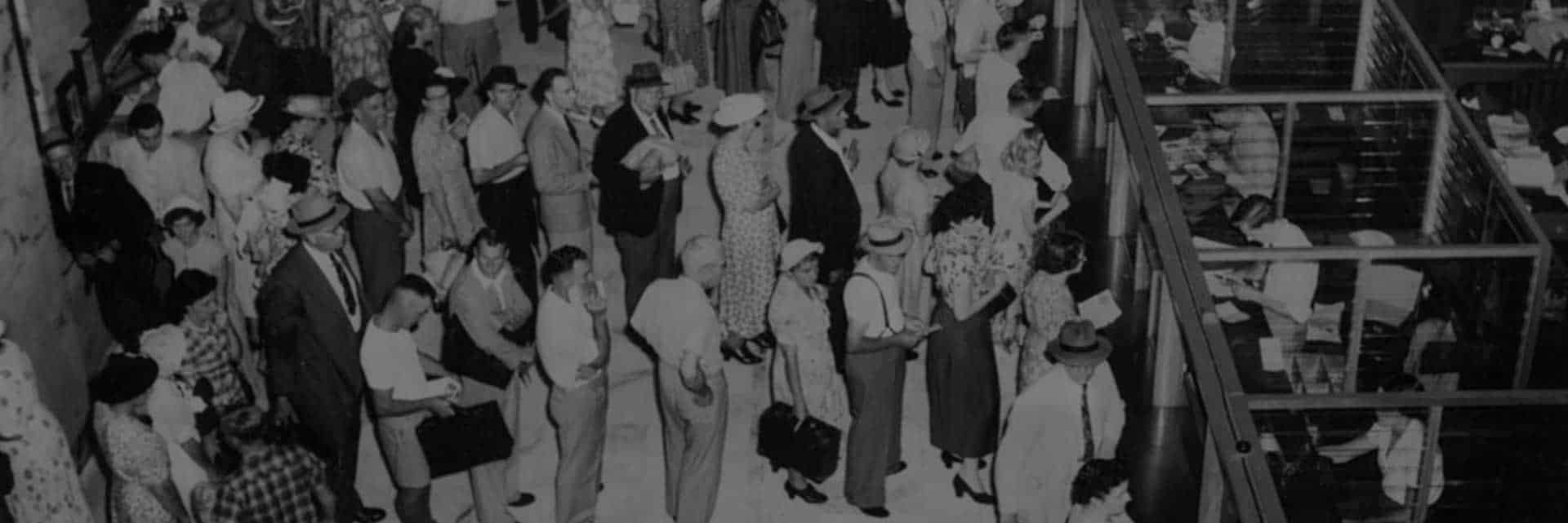 old black and white image of people in line at a bank
